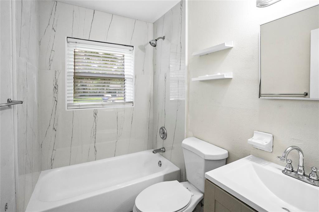 4138 Westgate Road Orlando, FL 32808 - Photo 25 of 29 a bathroom with a toilet a sink and bathtub