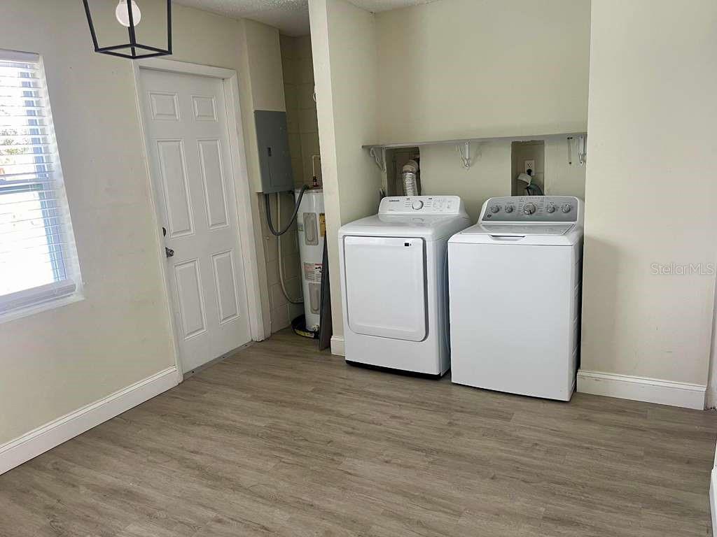 4138 Westgate Road Orlando, FL 32808 - Photo 27 of 29 a view of a storage & utility room with a washer dryer