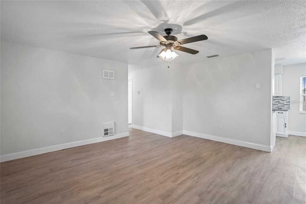 4138 Westgate Road Orlando, FL 32808 - Photo 8 of 29 a view of an empty room with wooden floor