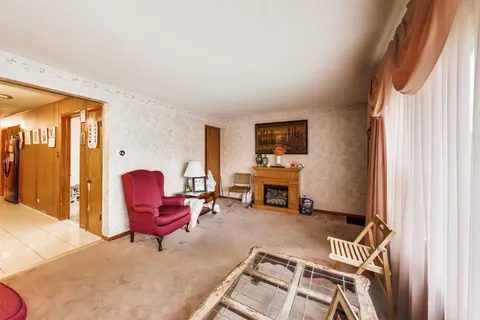 a living room with furniture a fireplace and city view