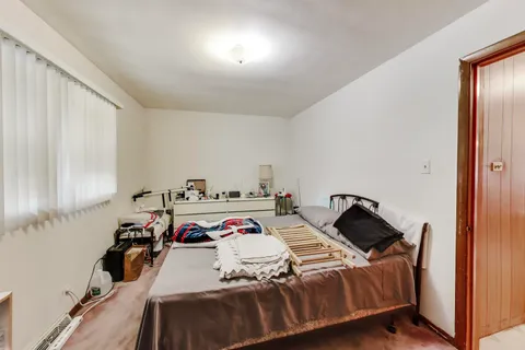 a bedroom with bed and a window