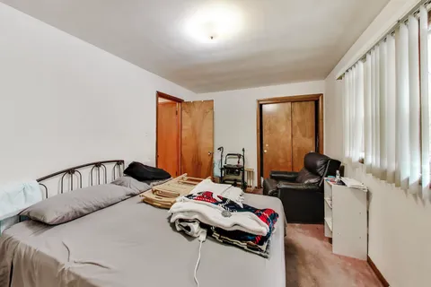 a bedroom with furniture and a window