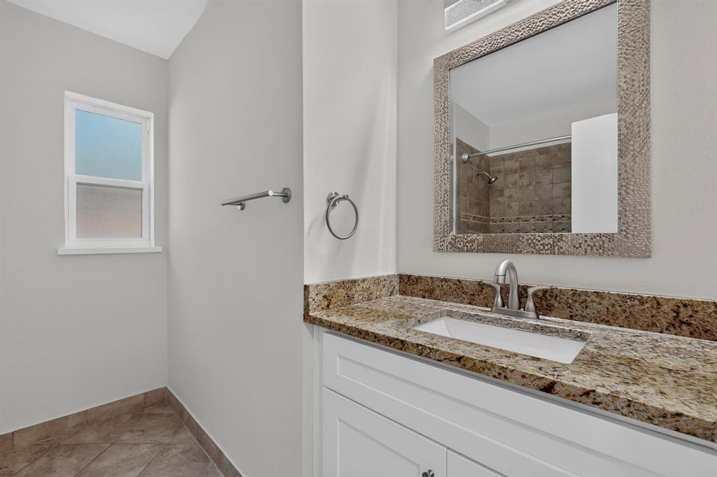 405 Easton Road Dallas, TX 75218 - Photo 20 of 36 Bathroom vanity featuring a light-toned granite countertop with an undermount sink and brushed nickel faucet