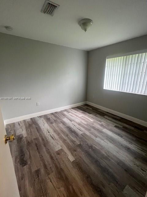 3985 Northwest 165th Street Miami Gardens, FL 33054 - Photo 6 of 9 wooden floor in an empty room with a window