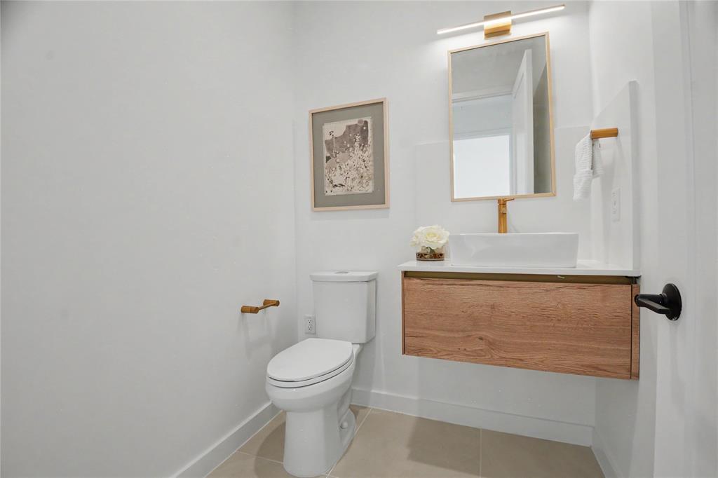 1111 Raiford Road, Unit 104 Carrollton, TX 75007 - Photo 11 of 30 a bathroom with a granite countertop sink a toilet and mirror