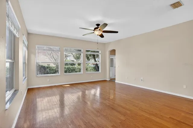wooden floor in an empty room with a window