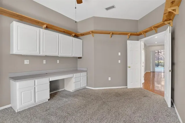 a view of kitchen with stainless steel appliances granite countertop a refrigerator and a sink
