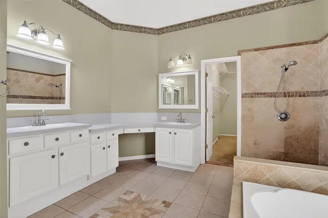 a spacious bathroom with double vanity and a mirror