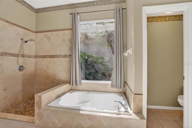 a bathroom with a tub and shower