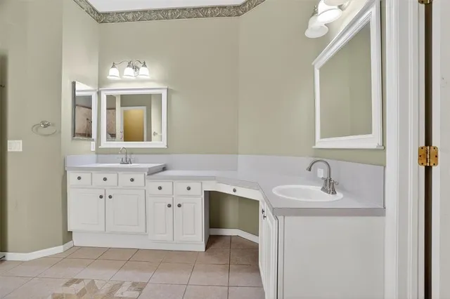 a bathroom with a sink vanity and mirror