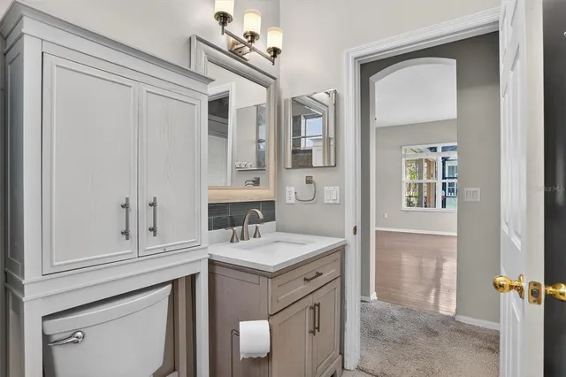 a bathroom with a sink vanity and mirror