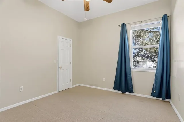 an empty room with windows and closet