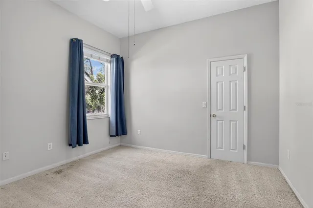 an empty room with windows and closet