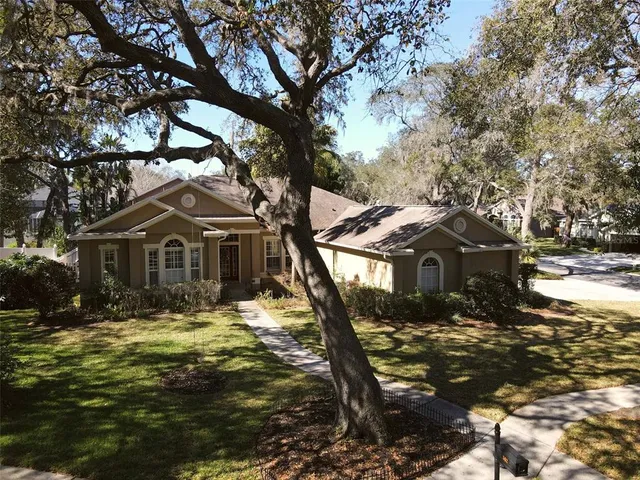 a front view of a house with a yard covered with snow