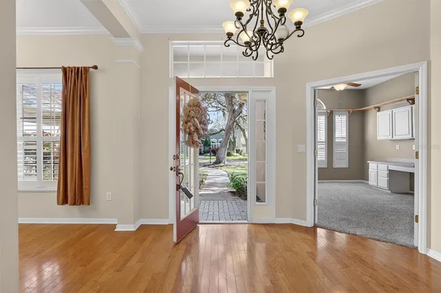 a view of entryway with wooden floor and a livingroom