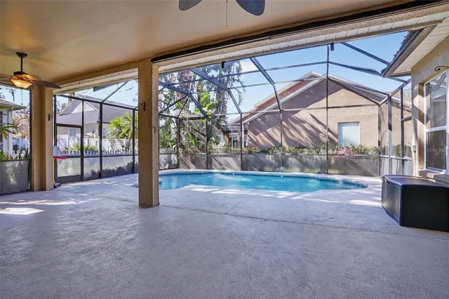 a view of empty room with floor to ceiling window and tree