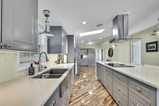 a kitchen with stainless steel appliances a sink and cabinets