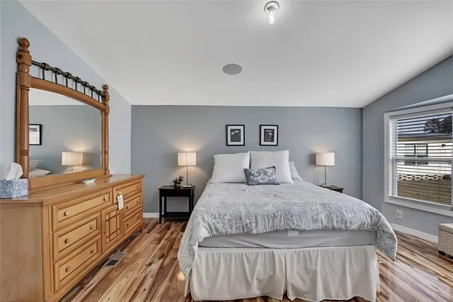a bedroom with a bed and a dresser