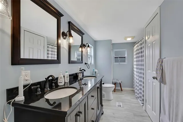 a bedroom with a large bed and a large mirror