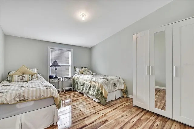 a spacious bedroom with a bed and windows