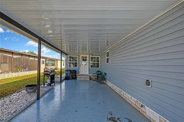 a view of a porch with wooden floor chairs and a table