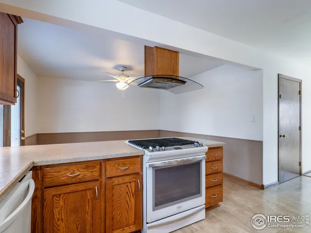 a kitchen with stainless steel appliances granite countertop a stove and a microwave