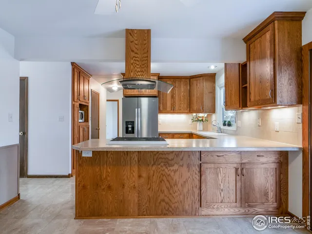 a kitchen with a sink cabinets and appliances