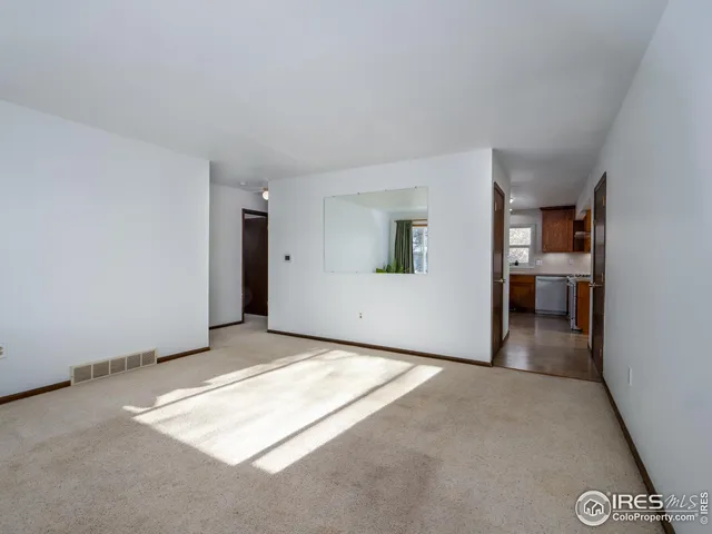 a view of livingroom with kitchen and window