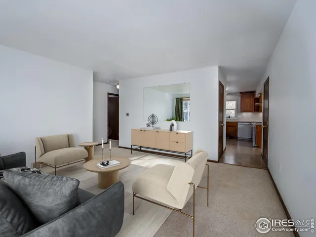 a living room with furniture and kitchen view