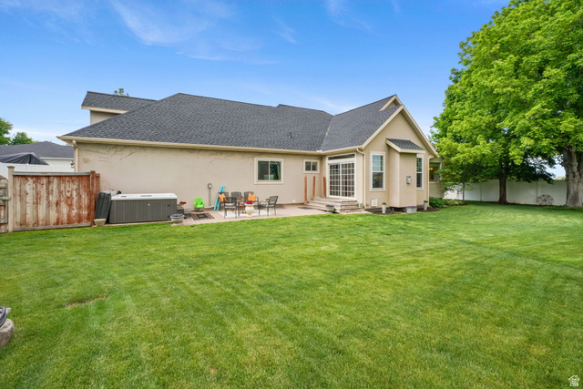 357 South 320 W Street Lindon, UT 84042 - Photo 36 of 41 Spacious backyard featuring a large green lawn, a patio, and mature trees