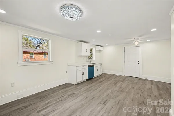 a view of a kitchen with wooden floor