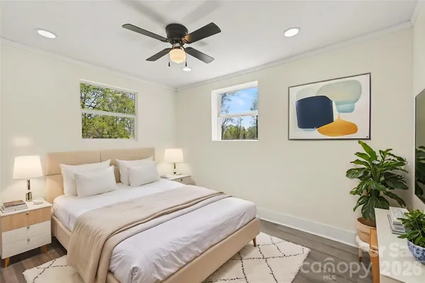 a bedroom with a bed and a potted plant