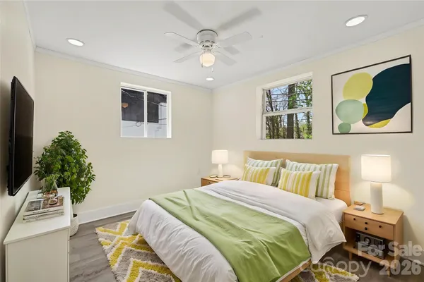 a bedroom with a bed and a potted plant