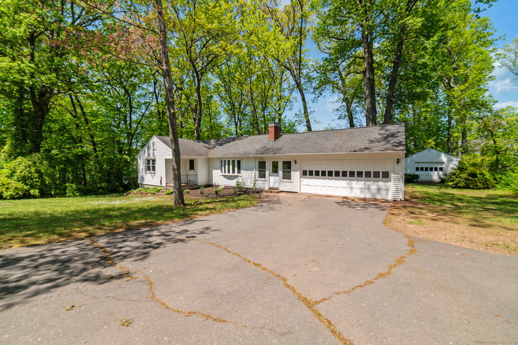 a view of house with outdoor space and trees
