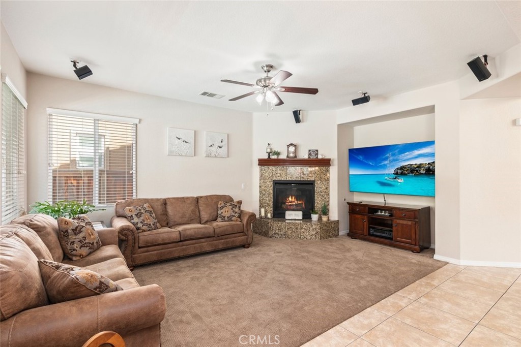 46123 Drymen Avenue Temecula, CA 92592 - Photo 13 of 42 a living room with furniture a fireplace and a flat screen tv