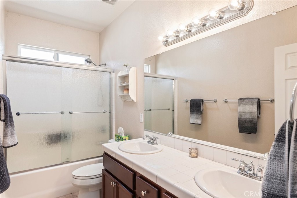 46123 Drymen Avenue Temecula, CA 92592 - Photo 24 of 42 a bathroom with a sink a toilet and shower