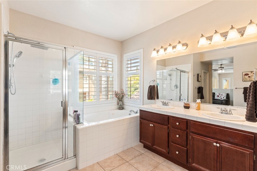 46123 Drymen Avenue Temecula, CA 92592 - Photo 29 of 42 a bathroom with a tub sink double vanity and mirror