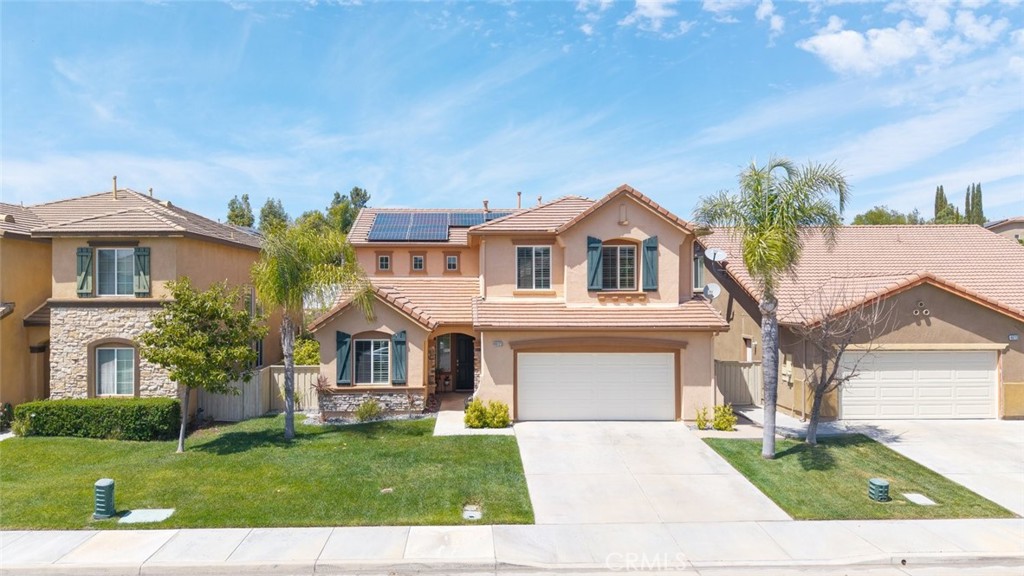 46123 Drymen Avenue Temecula, CA 92592 - Photo 6 of 42 a front view of a house with a garden and yard