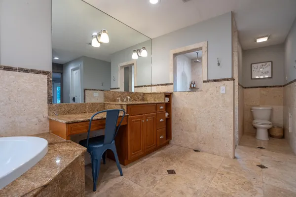 a living room with furniture a large window and a fireplace