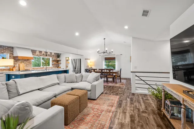 a kitchen with a sink a wooden cabinets and a large window