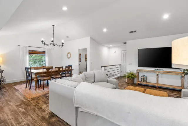 a bedroom with a bed lamp and a large window