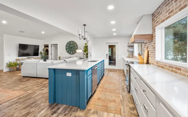 a bedroom with two beds and a chandelier