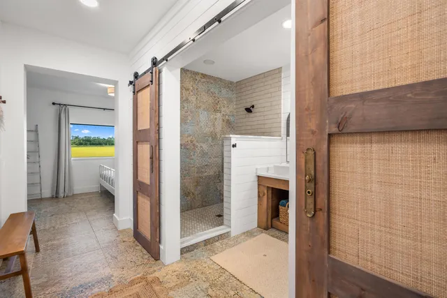 a bathroom with a granite countertop toilet sink and mirror
