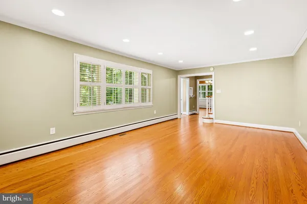 a view of a livingroom with furniture and a hallway