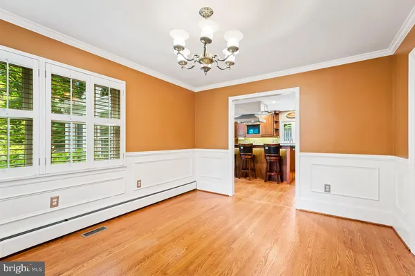 a kitchen with stainless steel appliances granite countertop a refrigerator a stove and a wooden cabinets