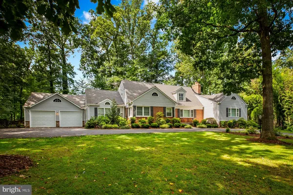 a front view of a house with yard and green space