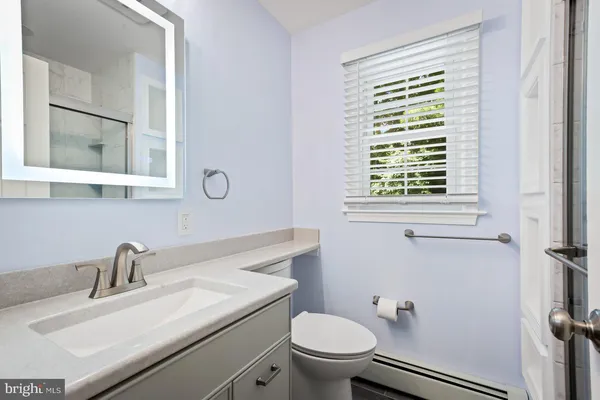 a bathroom with a glass shower door