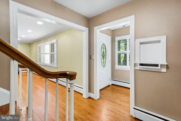 an empty room with wooden floor and a window