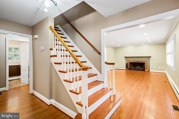 an empty room with a fireplace and windows