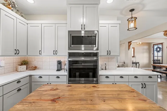 a kitchen with stainless steel appliances a stove sink and cabinets